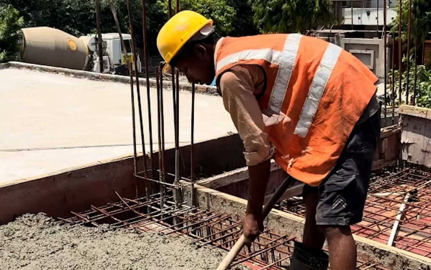 A slab being poured over laid reinforcement on an UrbanKriti site